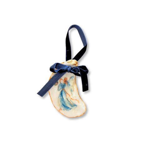 Decoupage oyster shell ornament with a blue-robed angel playing a trumpet, gilded rim, and navy velvet ribbon by Melissa Fouts.