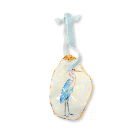 Decoupage oyster shell ornament with a watercolor blue heron on a pale blue velvet ribbon by Melissa Fouts