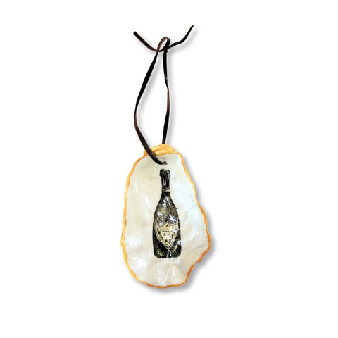 Decoupage oyster shell ornament with a champagne bottle on a black velvet ribbon by Melissa Fouts