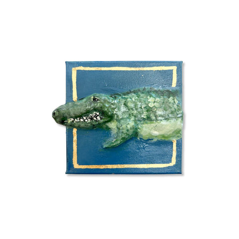 Alligator breaking out of a gold-leaf frame on blue 6x6 canvas, paper mache art by Annie Aymond