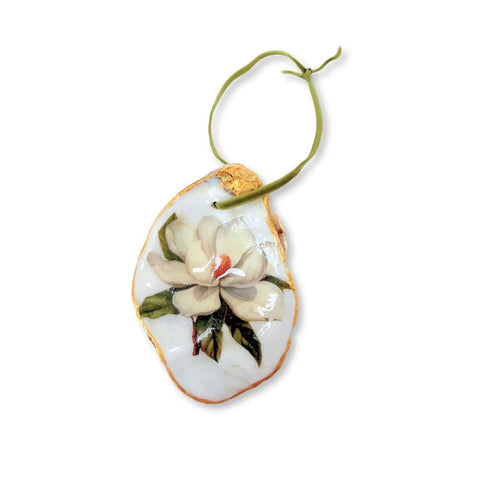 Decoupage oyster shell ornament with a white magnolia blossom on a green ribbon by Melissa Fouts