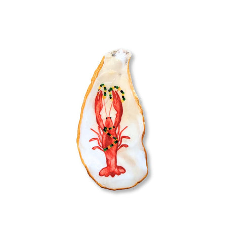 Decoupage oyster shell dish with a red crawfish wearing Mardi Gras beads and a gilded rim by Melissa Fouts.